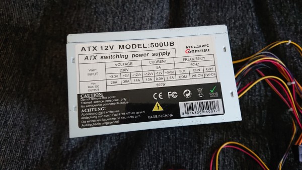 Photo of a PC power supply, showing the rated current and voltage table