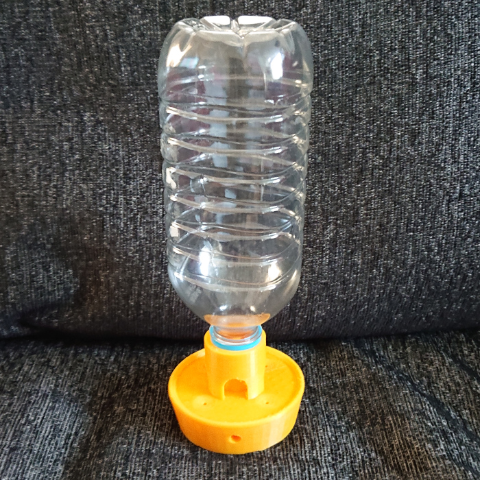 3D printed bird feeder attached to a reused plastic bottle