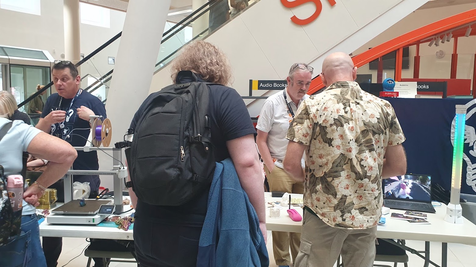 Chris and Adrian stood behind the MCQN table at Makefest, talking to visitors to the event