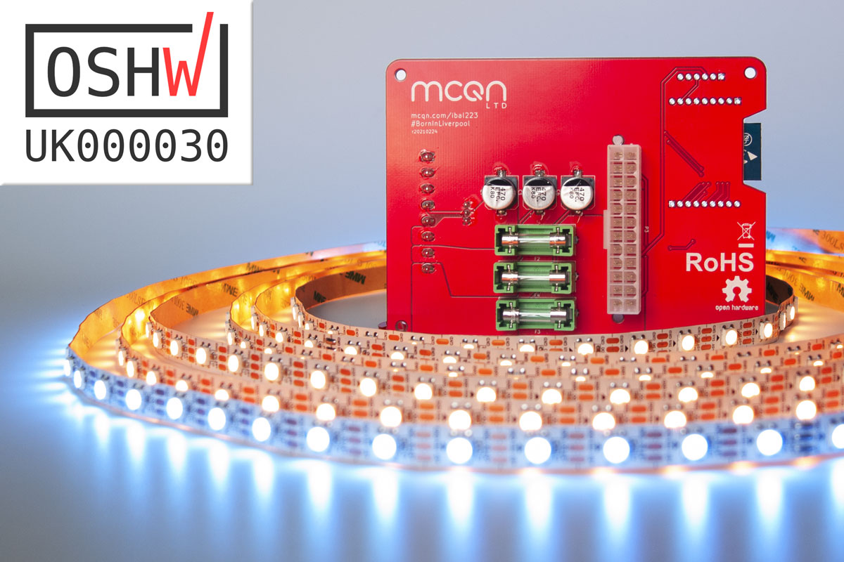 The red PCB surrounded by colourful lights, with the Open Source Hardware mark overlayed, reading UK00030