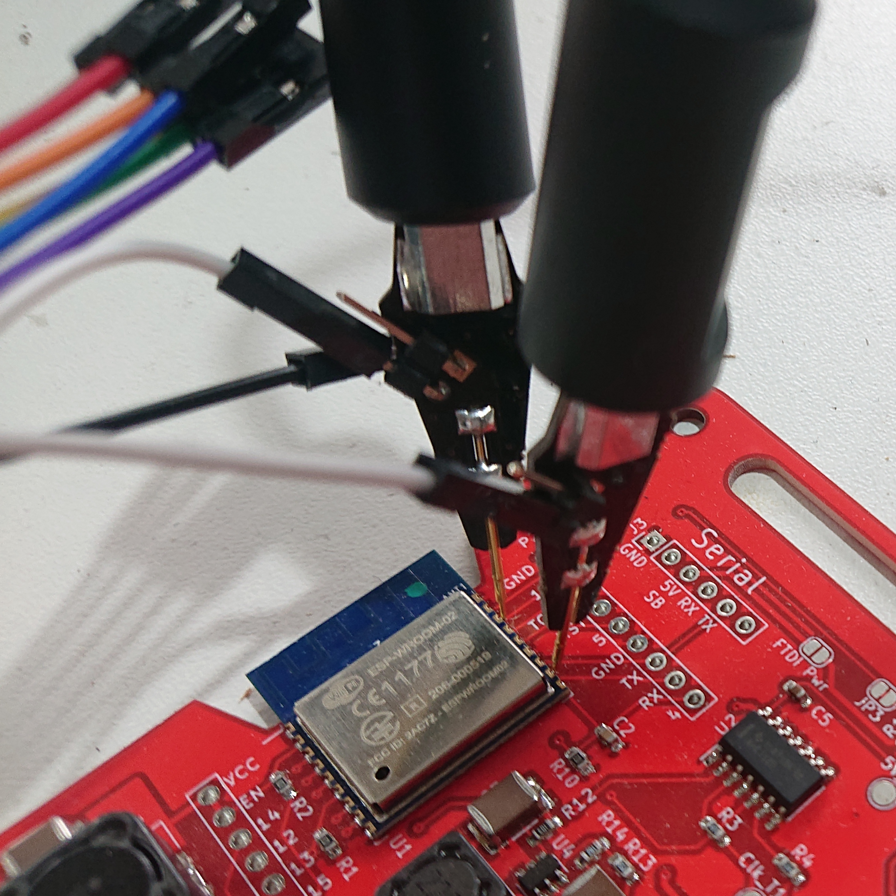 Zoomed in version of the previous photo showing a closer view of the probe pins connecting to points on the ESP8266 on the board
