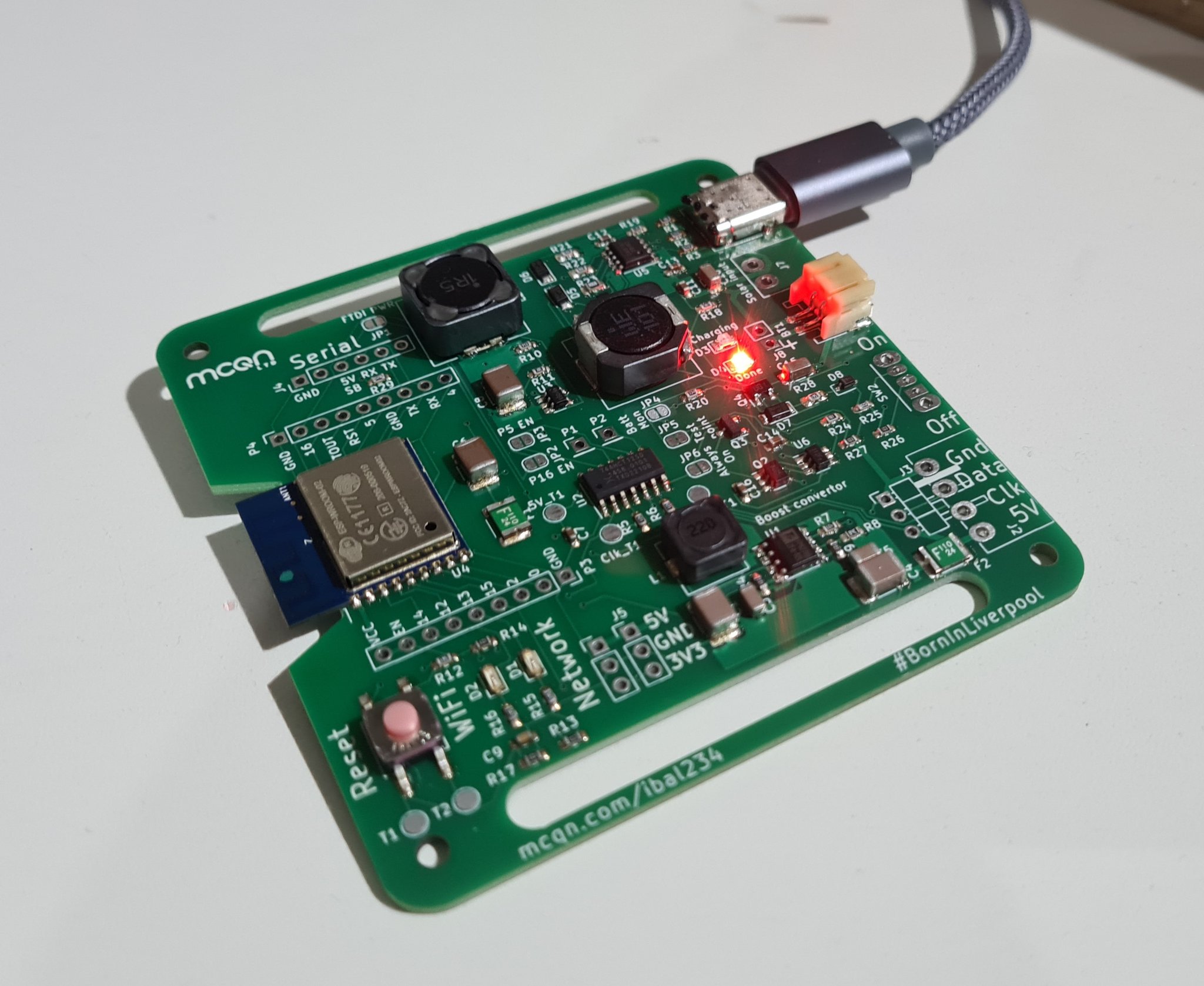 Green circuit board plugged into a USB supply with perhaps more components than is justified for the single lit red led