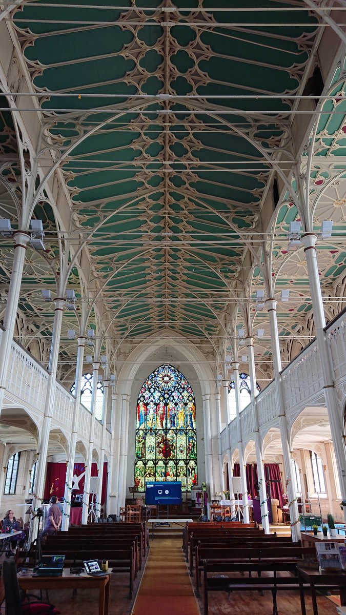 The inside of a church showing the ornate iron columns and decorative ironwork of its construction