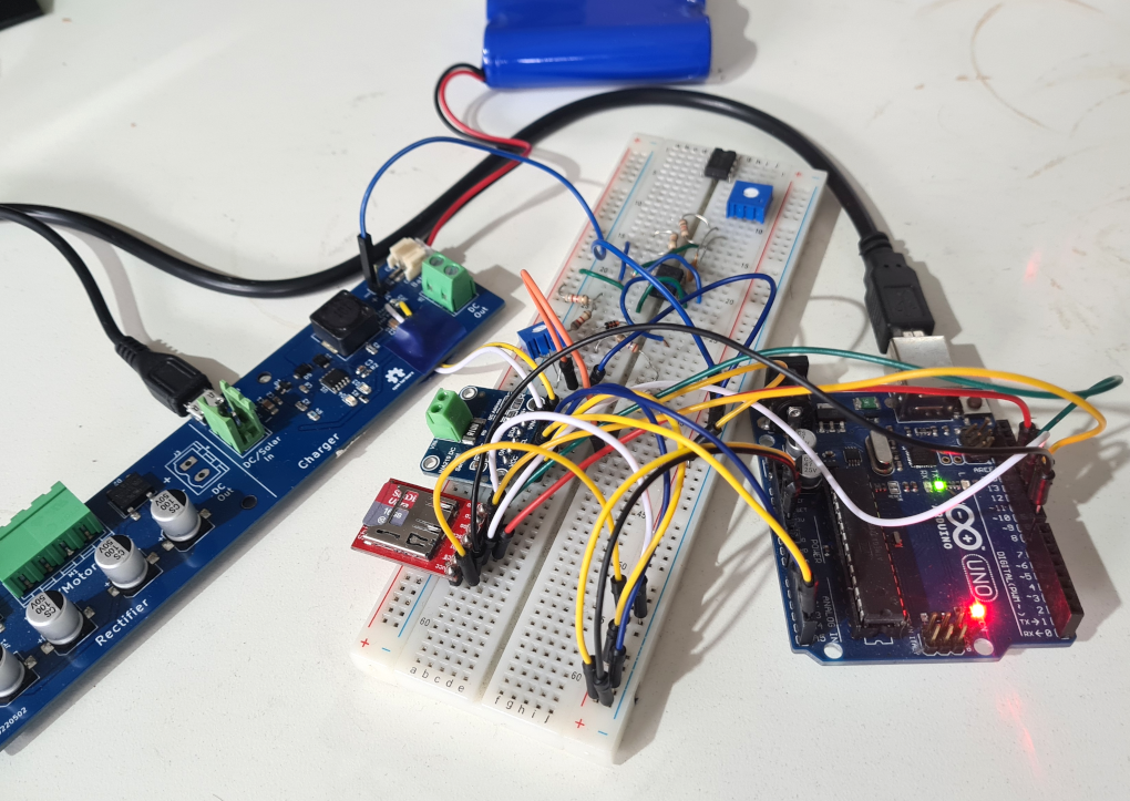 Breadboard, Arduino and a nest of wires collecting battery charging data with a ina219 current sensor